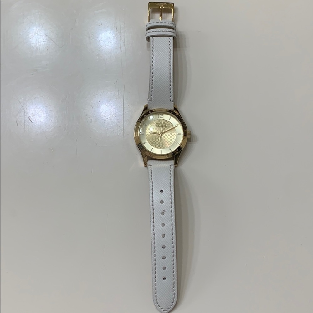 Coach watch in gold with  cream leather band